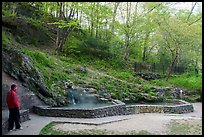 Visitor looking, hot spring cascade. Hot Springs National Park ( color)