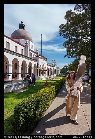 Man dressed as Jesus walking with cross on Bathhouse Row. Hot Springs National Park (color)