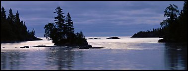 North woods lakescape with silhouetted trees. Isle Royale National Park, Michigan, USA.