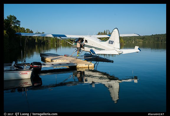 Pilot opening door at floatplane dock. Isle Royale National Park, Michigan, USA.