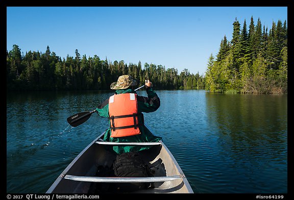 Canoist paddling seen from back, Tobin Harbor. Isle Royale National Park (color)