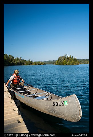 Canoist at dock, Tobin Harbor. Isle Royale National Park, Michigan, USA.