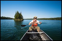 Canoist paddling and islet, Tobin Harbor. Isle Royale National Park ( color)