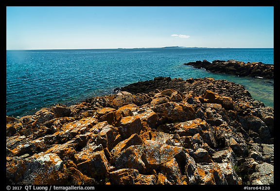 Lichen-covered rocks, Lake Superior, and Isle Royale from Passage Island. Isle Royale National Park, Michigan, USA.