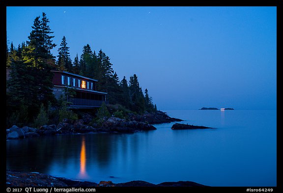 Rock Harbor Lodge at night with di Rock Harbor Lodge and moon at duskstant ship in shipping lane in front of Passage Island. Isle Royale National Park, Michigan, USA.