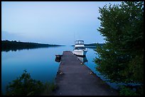 Moskey Basin dock with motorboat and ycaht, dusk. Isle Royale National Park ( color)