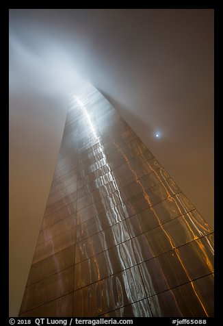 Moon and Gateway Arch south pillar soaring into clouds. Gateway Arch National Park (color)