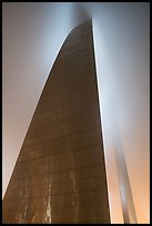 Profile view of Gateway Arch with top in clouds at night. Gateway Arch National Park, St Louis, Missouri, USA.