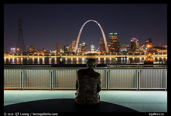 St Louis skyline and Malcom Martin statue from Mississippi River Overlook at night. Gateway Arch National Park, St Louis, Missouri, USA.