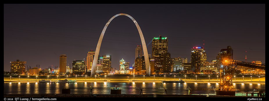 St Louis skyline from Mississippi River Overlook at night. Gateway Arch National Park, St Louis, Missouri, USA.