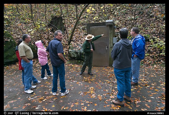 Ranger pointing to cave entrance to tourists. Mammoth Cave National Park, Kentucky, USA.