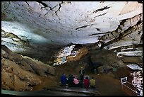 Tourists listening at ranger in large room inside cave. Mammoth Cave National Park, Kentucky, USA. (color)