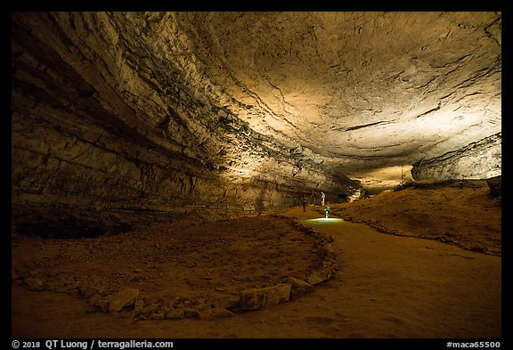 Visitors walk down huge corridor in cave. Mammoth Cave National Park (color)