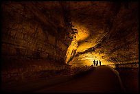 Family backlighted in dark cave corridor. Mammoth Cave National Park ( color)