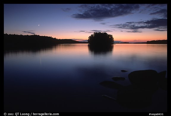 Sunset with moon and island on Kabetogama Lake near Ash river. Voyageurs National Park, Minnesota, USA.