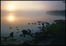Rocky shoreline, Sunrise and morning fog, Kabetogama Lake. Voyageurs National Park, Minnesota, USA.