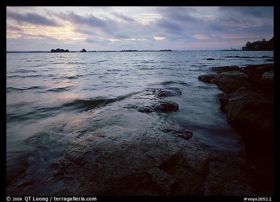 Lakeshore with eroded granite slab and clouds. Voyageurs National Park (color)