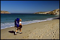 Backpacker on beach, Cuyler harbor, San Miguel Island. Channel Islands National Park, California, USA.