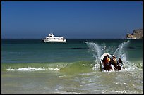 Skiff going back to main boat through surf, Cuyler harbor, San Miguel Island. Channel Islands National Park, California, USA.