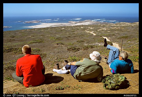 Hikers observing Point Bennett from a distance, San Miguel Island. Channel Islands National Park, California, USA.