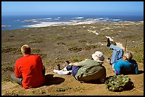 Hikers observing Point Bennett from a distance, San Miguel Island. Channel Islands National Park, California, USA.