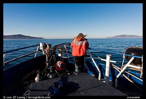 Woman standing on bow of boat sailing towards Annacapa and Santa Cruz Islands. Channel Islands National Park (color)