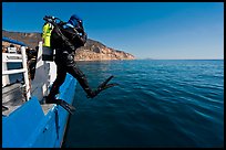 Scuba diver stepping out of boat, Santa Cruz Island. Channel Islands National Park, California, USA. (color)