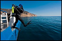 Scuba diver stepping out of boat, Santa Cruz Island. Channel Islands National Park, California, USA.