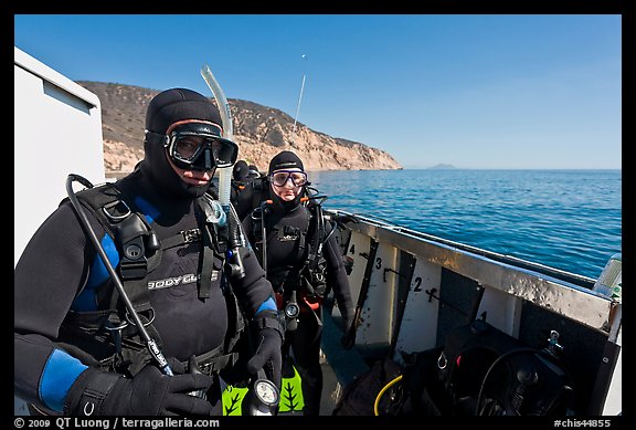 Scuba divers in wetsuits ready to dive from boat, Santa Cruz Island. Channel Islands National Park, California, USA.