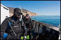 Scuba divers in wetsuits ready to dive from boat, Santa Cruz Island. Channel Islands National Park, California, USA.