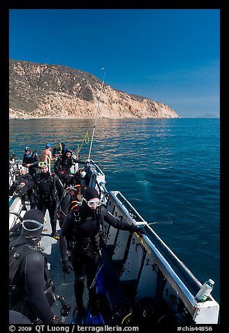 Divers in full wetsuits on diving boat, Santa Cruz Island. Channel Islands National Park, California, USA.