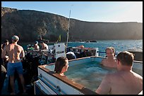 Divers relaxing in hot tub aboard the Spectre and Annacapa Island. Channel Islands National Park, California, USA.