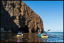 Kayakers paddling in kelp at base of sea cliff, Santa Cruz Island. Channel Islands National Park ( color)