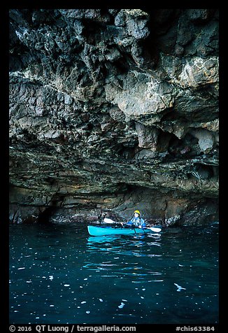 Kayaker in sea cave with low ceiling, Santa Cruz Island. Channel Islands National Park (color)
