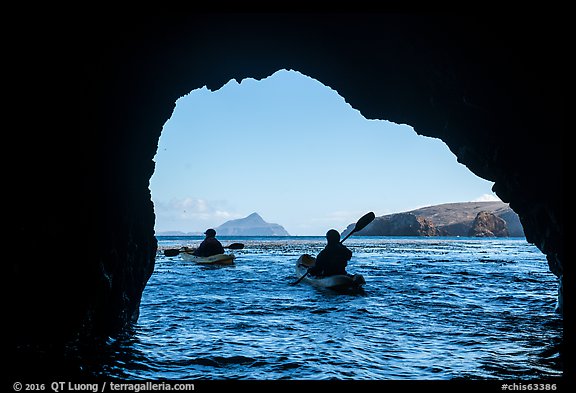 Kayakers exiting sea cave with West Anacapa in the distance, Santa Cruz Island. Channel Islands National Park (color)