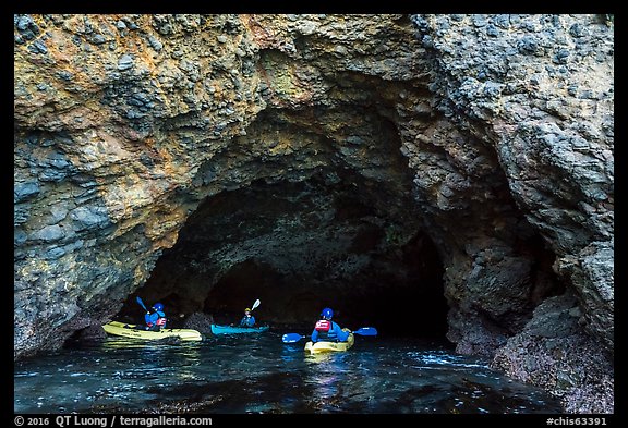 Kayakers at the entrance of sea cave, Santa Cruz Island. Channel Islands National Park (color)