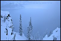Trees and mistly lake in winter. Crater Lake National Park, Oregon, USA. (color)