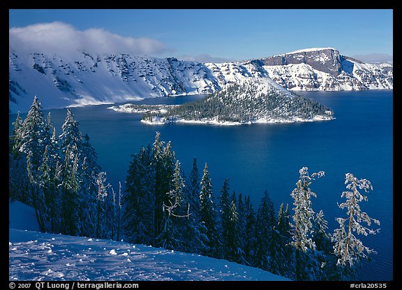 Lake and Wizard Island in winter, sunny afternoon. Crater Lake National Park, Oregon, USA.