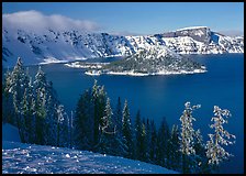 Lake and Wizard Island in winter, sunny afternoon. Crater Lake National Park, Oregon, USA.