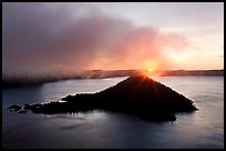 Sun rising behind Wizard Island. Crater Lake National Park, Oregon, USA. (color)