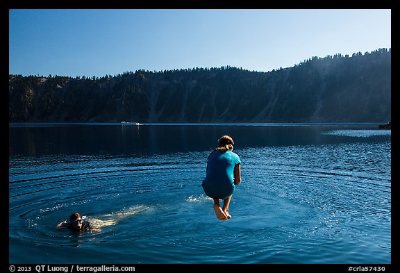 Girl jumps in water in Governors Bay, Wizard Island. Crater Lake National Park (color)