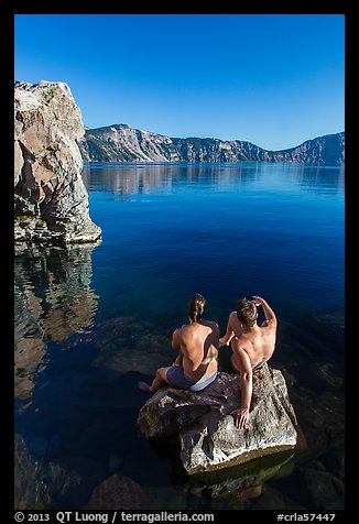 Men sunning on rock, Cleetwood Cove. Crater Lake National Park, Oregon, USA.