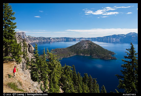 Visitor looking, Wizard Island and lake. Crater Lake National Park, Oregon, USA.