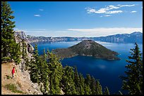 Visitor looking, Wizard Island and lake. Crater Lake National Park, Oregon, USA.