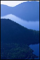 Wizard Island and crater rim profiles, early morning. Crater Lake National Park, Oregon, USA.