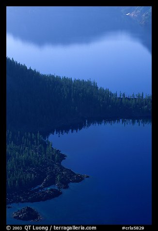 Wizard Island and crater rim reflection, early morning. Crater Lake National Park, Oregon, USA.