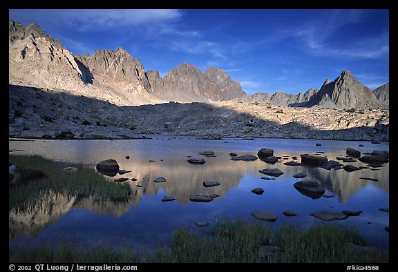 Mt Agasiz, Mt Thunderbolt, and Isoceles Peak reflected in a lake in Dusy Basin, late afternoon. Kings Canyon National Park, California, USA.