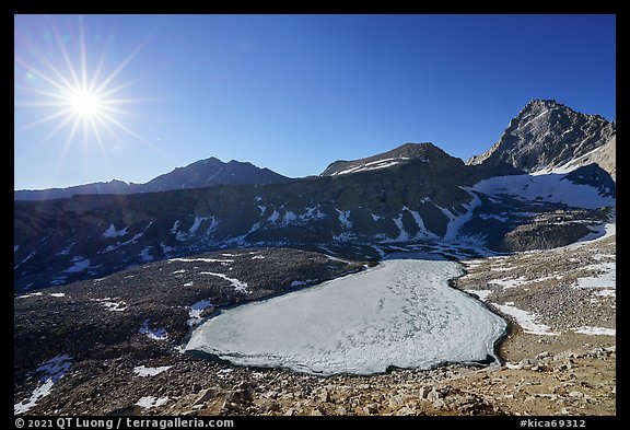 Sun and frozen lake from Forester Pass. Kings Canyon National Park, California, USA.