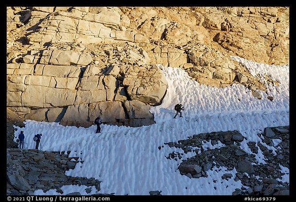 Hikers crossing a steep snowfield, Kings Canyon National Park. California