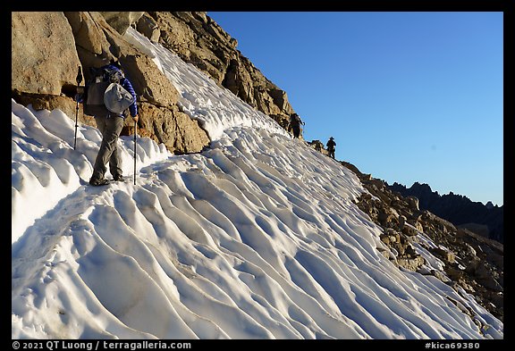 Hikers traversing a steep snowfield below Forester Pass, Kings Canyon National Park. California